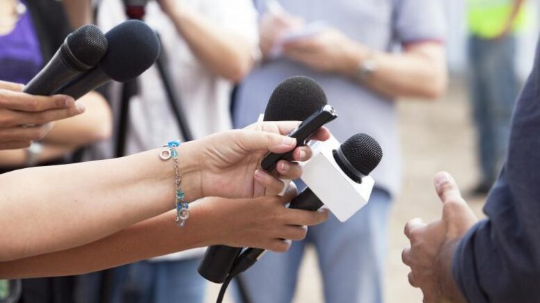 people-with-microphones-directing-them-at-man