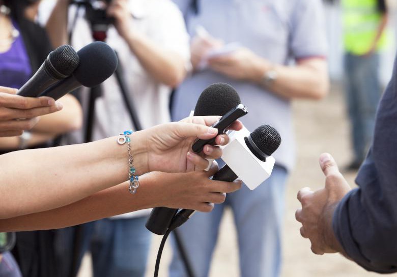 people-with-microphones-directing-them-at-man
